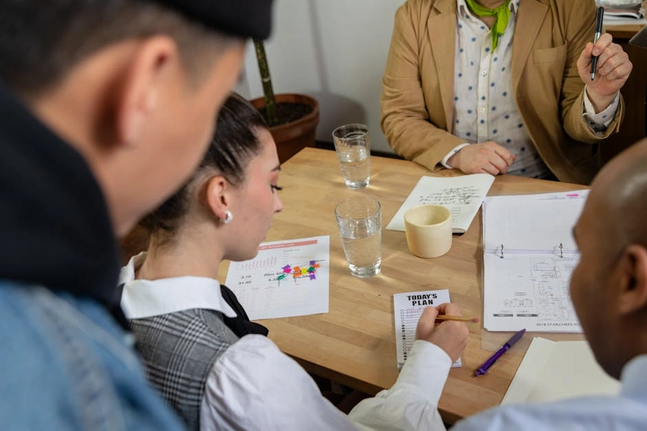 A team collaborating around a whiteboard with sticky notes.